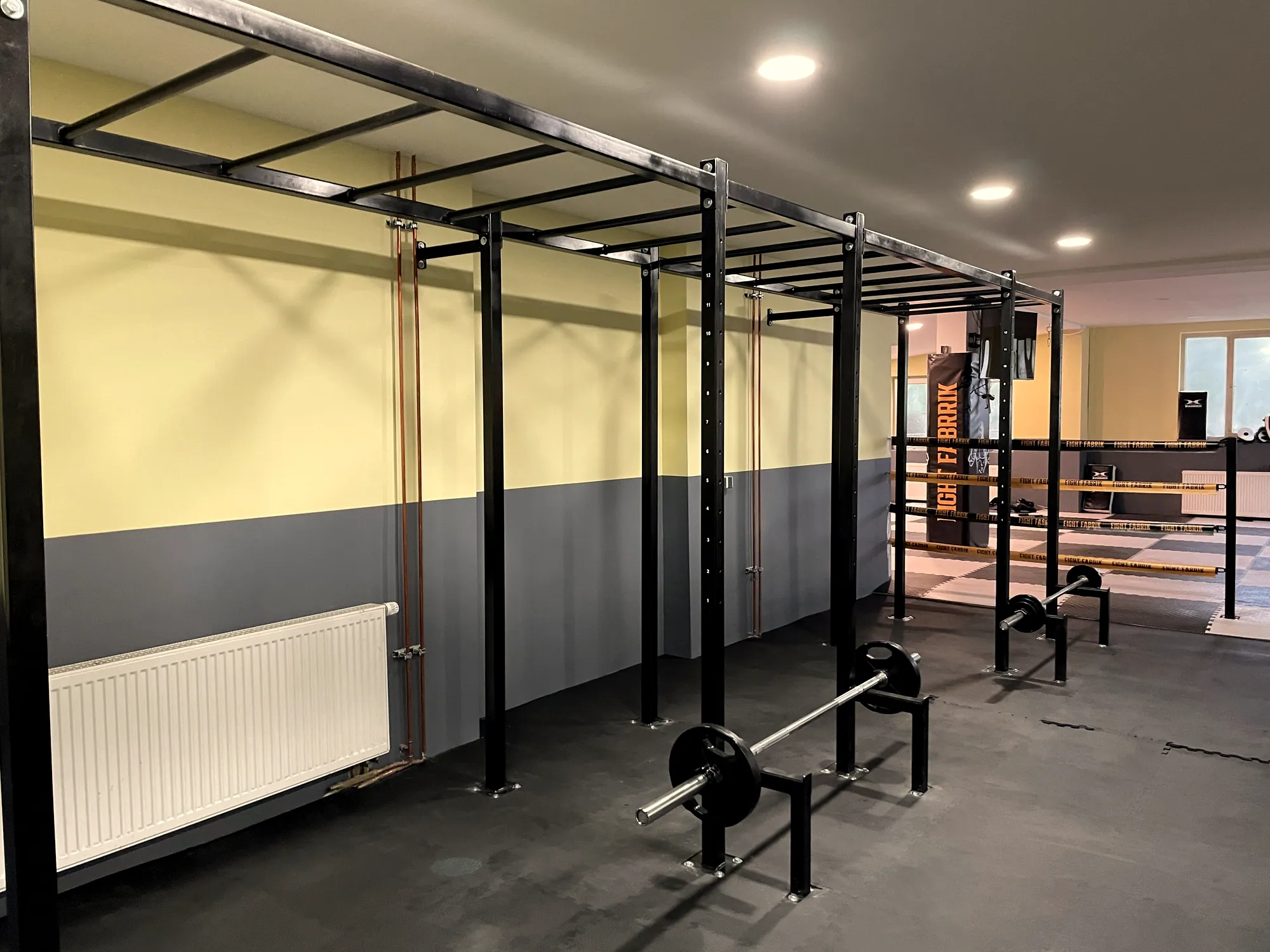 Steel power rack along the wall of a training room